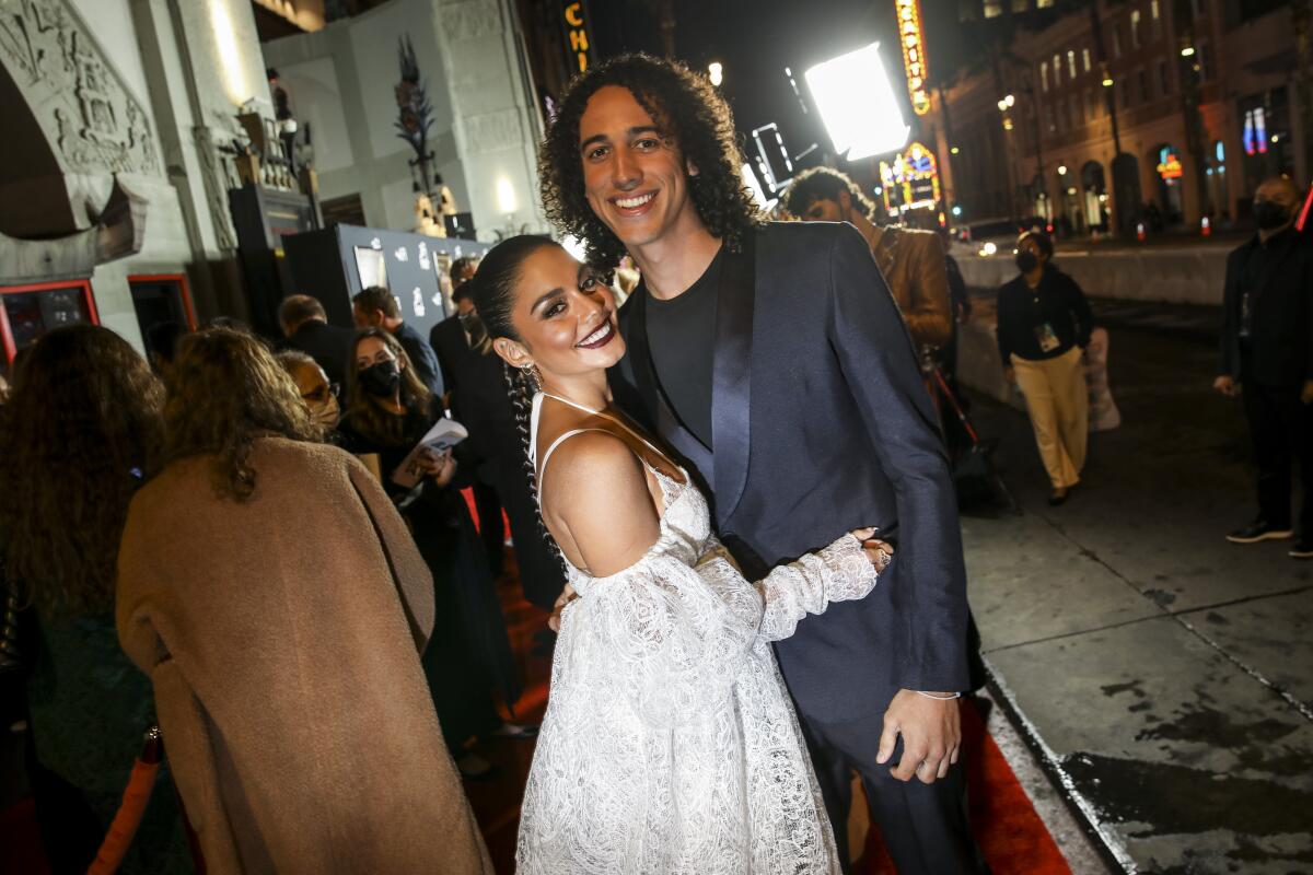Vanessa Hudgens poses with Cole Tucker with people in a line behind them