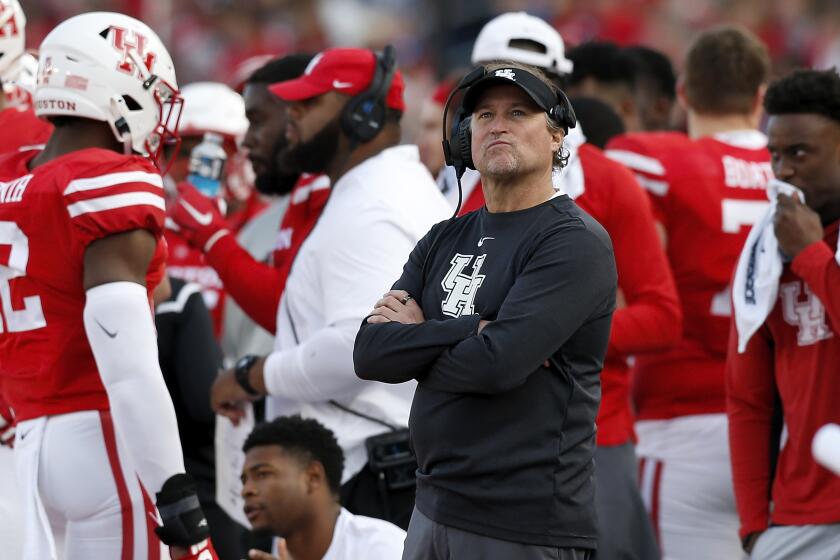 Houston coach Dana Holgorsen looks to the scoreboard during the second quarter of a 45-27 loss to Memphis on Nov. 16 at TDECU Stadium.