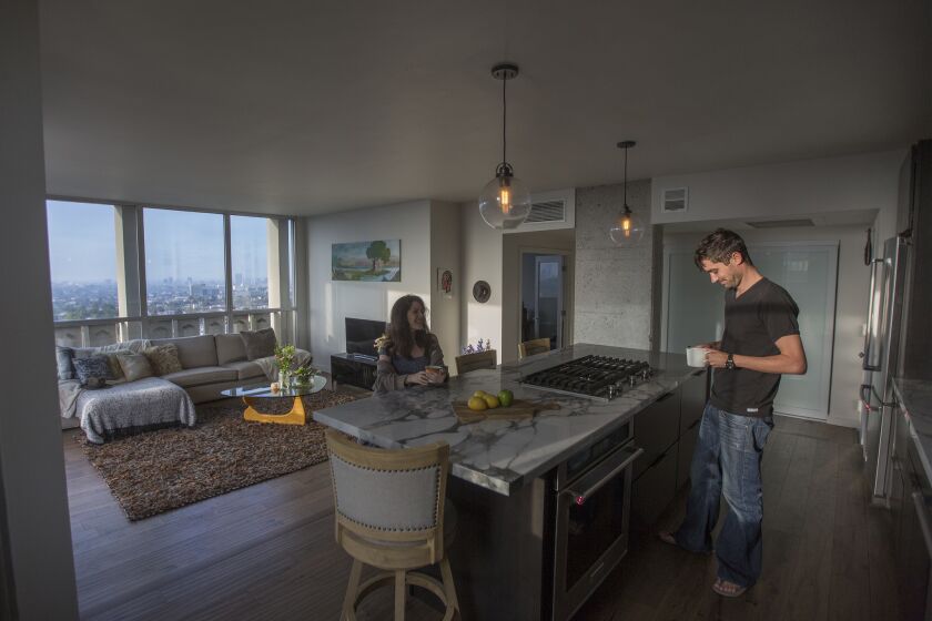 Actress Aleksa Palladino and cinematographer Needham Smith III are seen at home in their 1960s condominium.