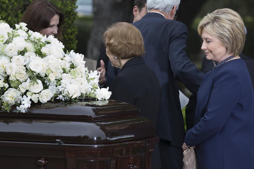 Hillary Clinton pauses before Nancy Reagan's casket at the former first lady's funeral in Simi Valley this month.