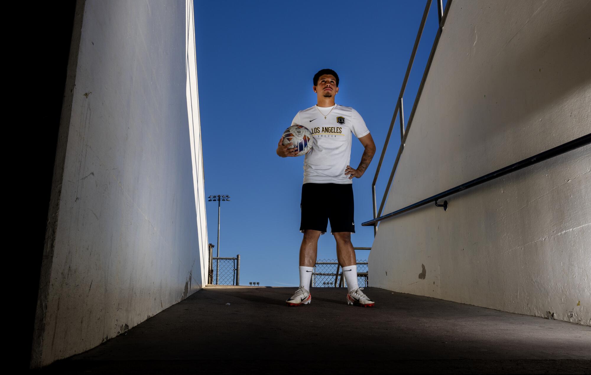 Bryan Ortega holds a soccer ball at Jesse Owens Stadium on the Cal State L.A. campus.