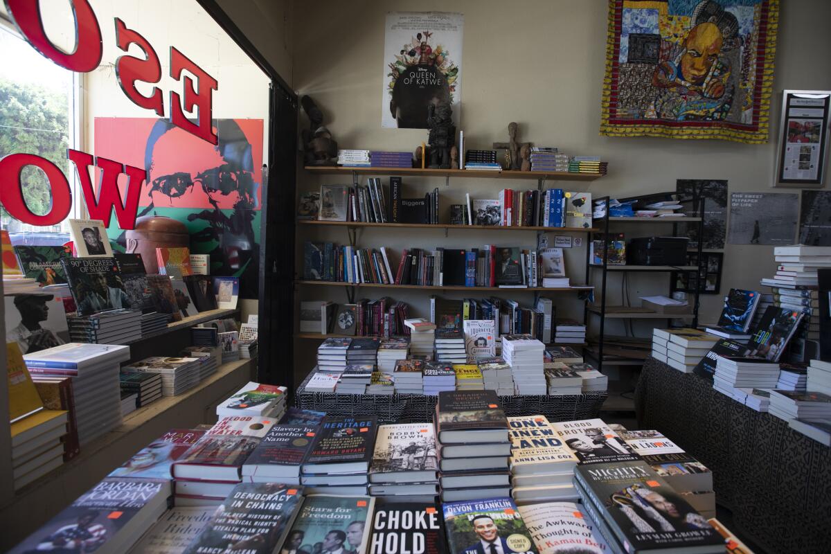 A table filled with stacks of books at a book shop.