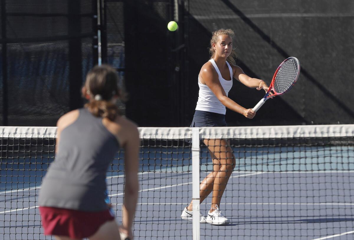 Corona del Mar's Cate Montgomery backhands a volley for point with partner Jane Paulsen on Tuesday.