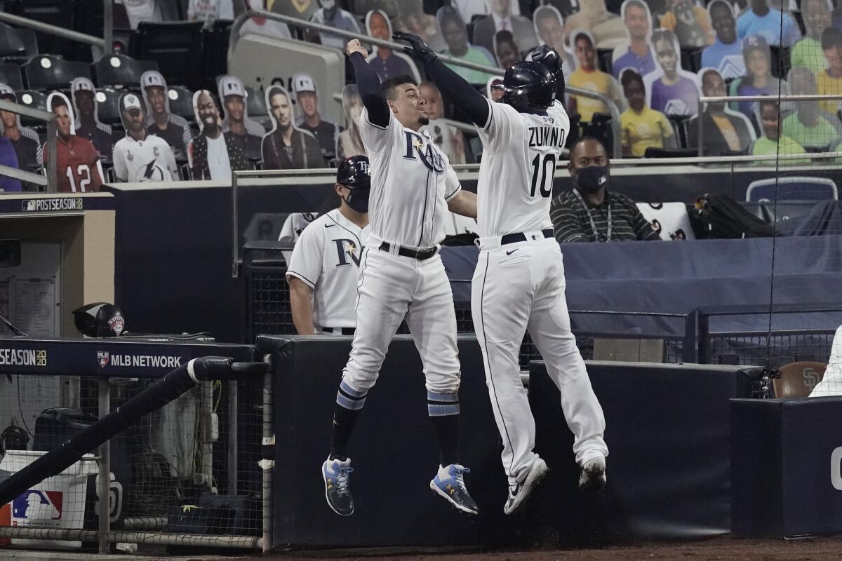 The Tampa Bay Rays' Willy Adames celebrates Mike Zunino's home run.