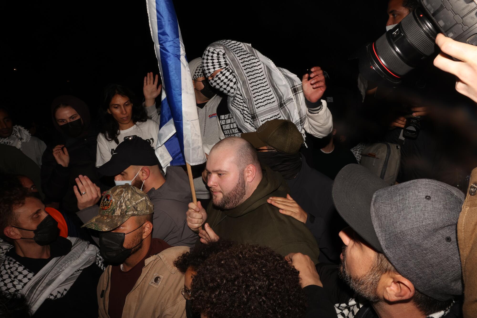 Pro-Palestine and pro-Israel demonstrators scuffle near a pro-Palestine encampment outside of Royce Hall at UCLA.