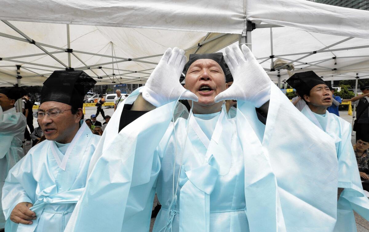Relatives of veterans attend a June 25 memorial service in Seoul marking the 65th anniversary of the start of the Korean War.