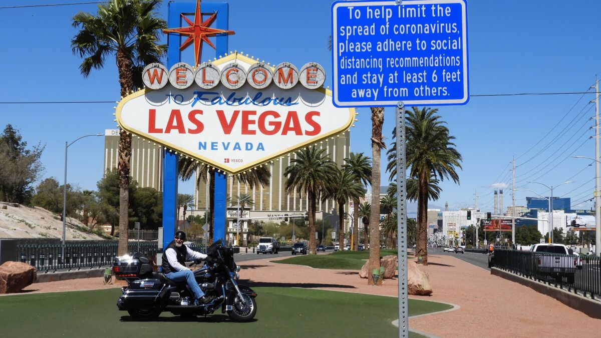 A motorcyclist took advantage of the quiet times to drive up to the Welcome to Las Vegas sign on March 24.