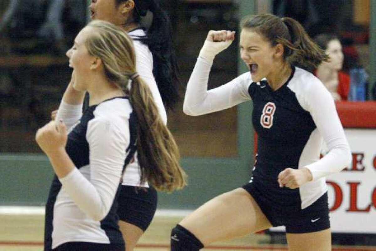 FSHA's Meghan Lacey, right, rejoices with her team after a kill. She had 14 kills on the night.