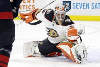 Anaheim Ducks goaltender John Gibson (36) gloves a shot from the Carolina Hurricanes.