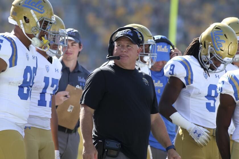 UCLA head coach Chip Kelly, center, walks with his players prior to an NCAA college football game against Arizona State, Saturday, Nov. 10, 2018, in Tempe, Ariz. (AP Photo/Ralph Freso)