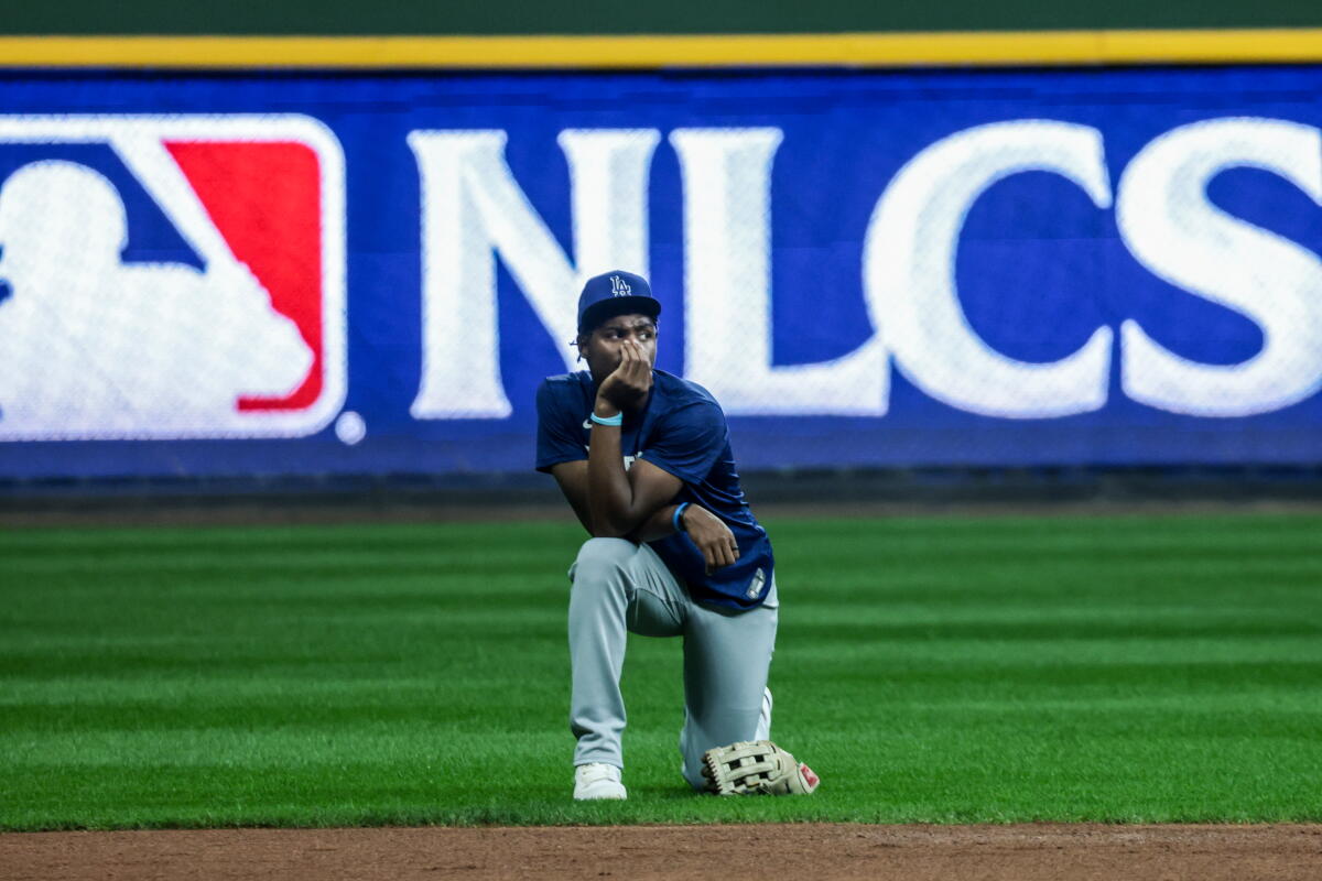 Dodgers rookie Josue DePaula kneels connected the section during practice.
