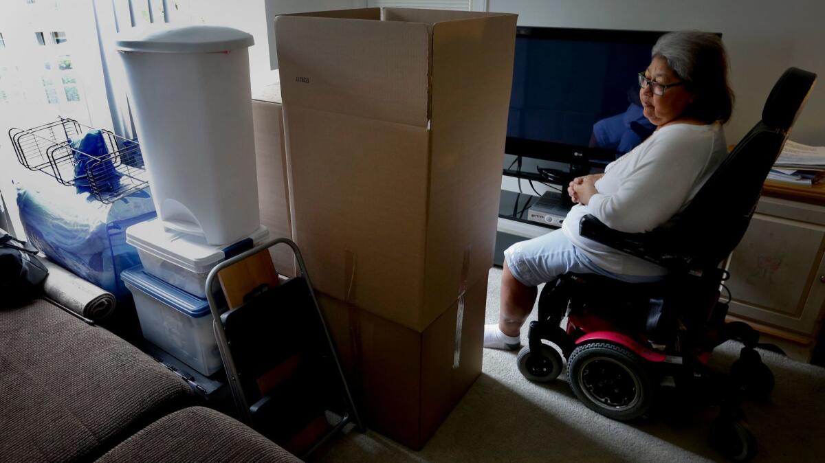 JoAnn Hesson, 68, sits among her moving boxes and personal belongings in her apartment in Rancho Santa Margarita. Hesson took out several high-interest installment loans in 2015 and is considering filing for bankruptcy. She has since moved to Phoenix to be closer to family.