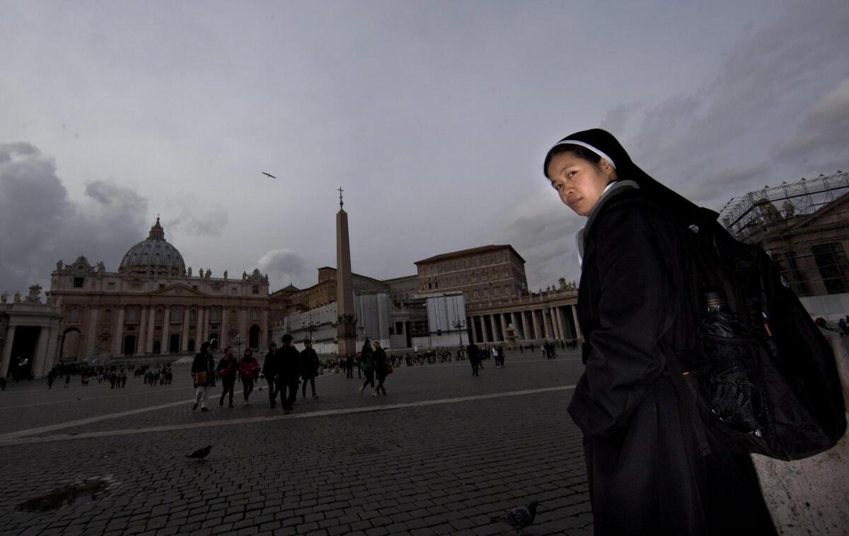 A nun stands in Saint Peter's Square, Vatican City, on Monday.