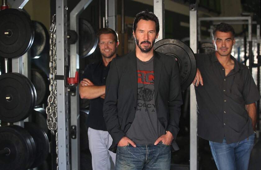 "John Wick" star Keanu Reeves is flanked by co-directors David Leitch, left, and Chad Stahelski, who also are top stunt coordinators.