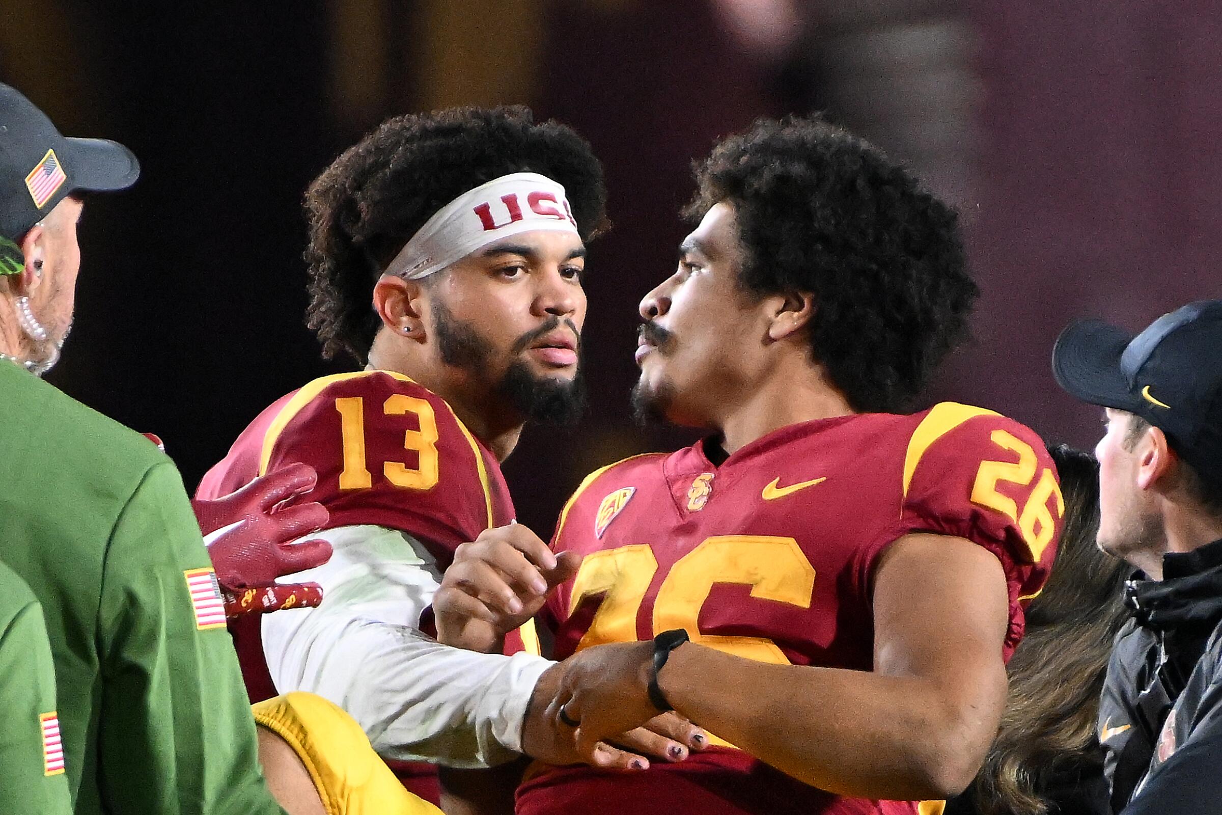 USC running back Travis Dye is consoled by quarterback Caleb Williams.