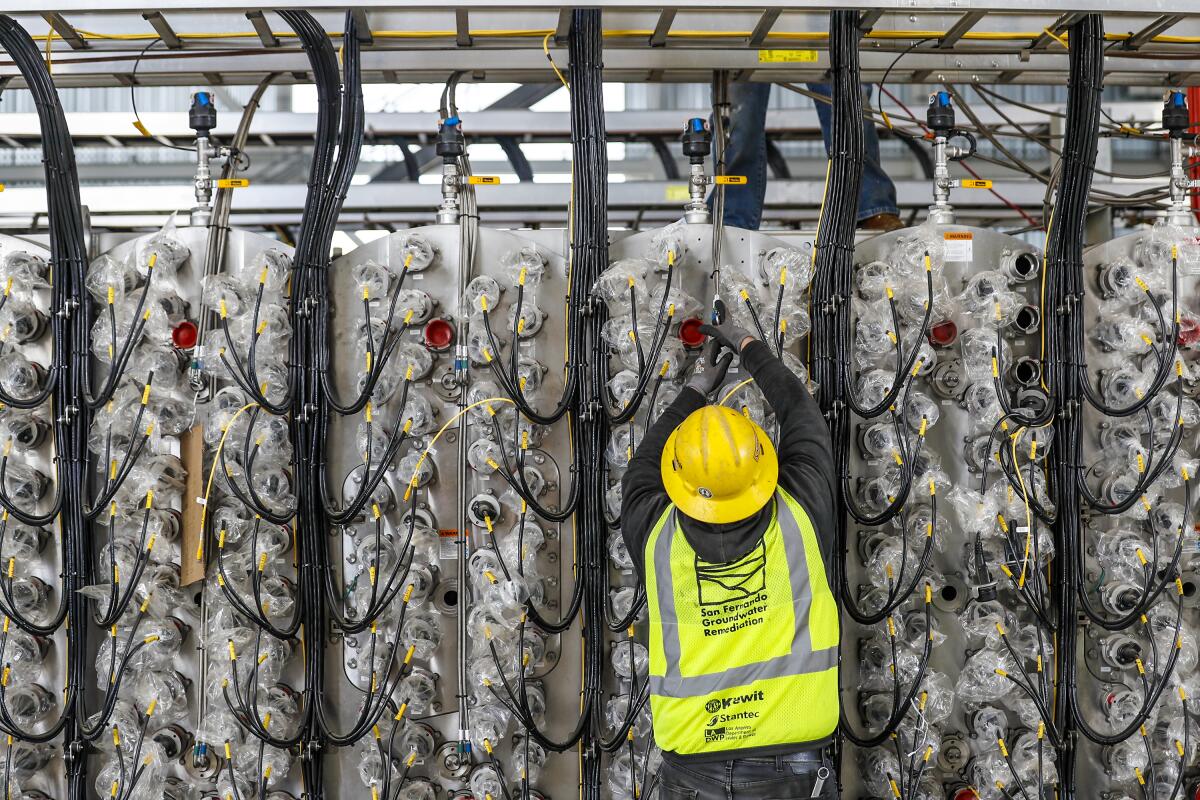 A worker assembles parts of an ultraviolet water treatment system at the LADWP Tujunga Spreading Grounds facility.