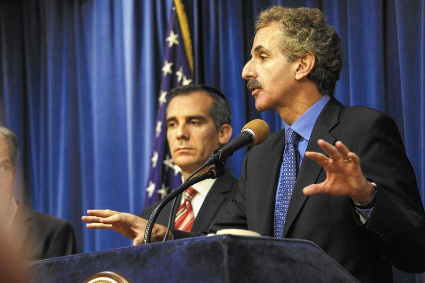 L.A. City Atty. Mike Feuer has "walled himself off" from his office's deliberations over a DWP lawsuit seeking to prevent the release of names and addresses of those who received turf rebates from the MWD. Feuer received a rebate.