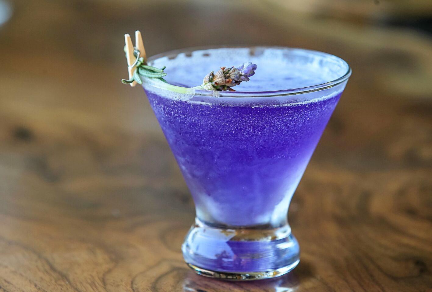 This is the Empress 75 drink: Empress gin, St. Germain, lavender syrup, fresh lemon, topped with sparkling wine.