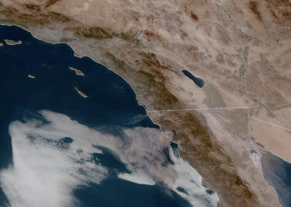 Brown smoke from a fire near Rosarito Beach, Mexico is drifting way out to sea and is visible from parts of San Diego.