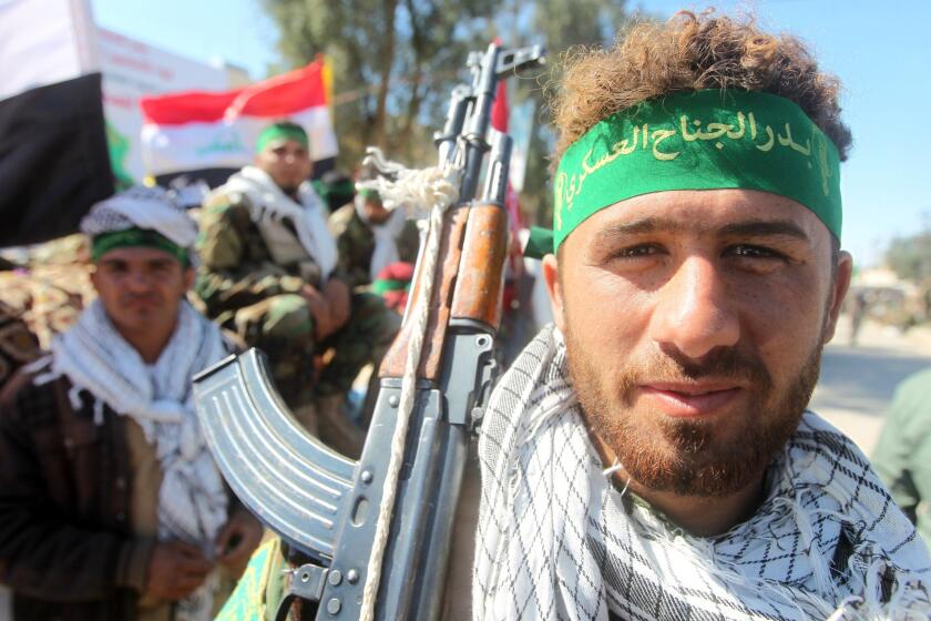 A volunteer Shiite Muslim fighter, a member of what is known as the Popular Mobilization Units, gathers with others in the city of Samarra on March 5 ahead of moving out toward Tikrit.