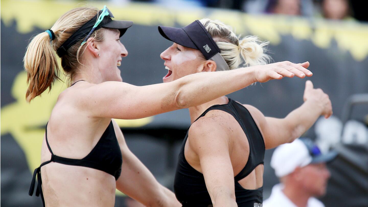 Emily Day, left, and Brittany Hochevar celebrate after beating Betsi Flint and Kelley Larsen during the AVP Huntington Beach Open women's championship match.