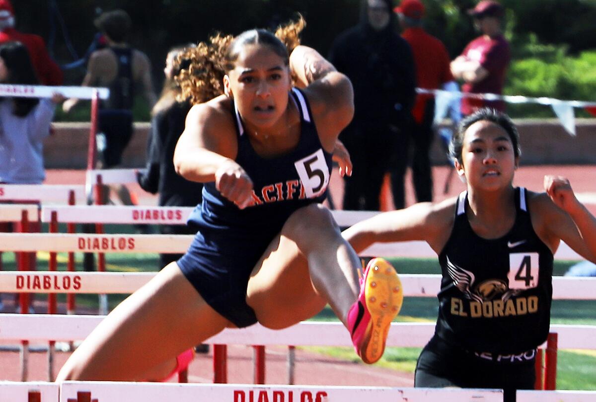 Pacific Christian's Charis Wondercheck competes in the 100-meter hurdles in the Orange County track and field championships.
