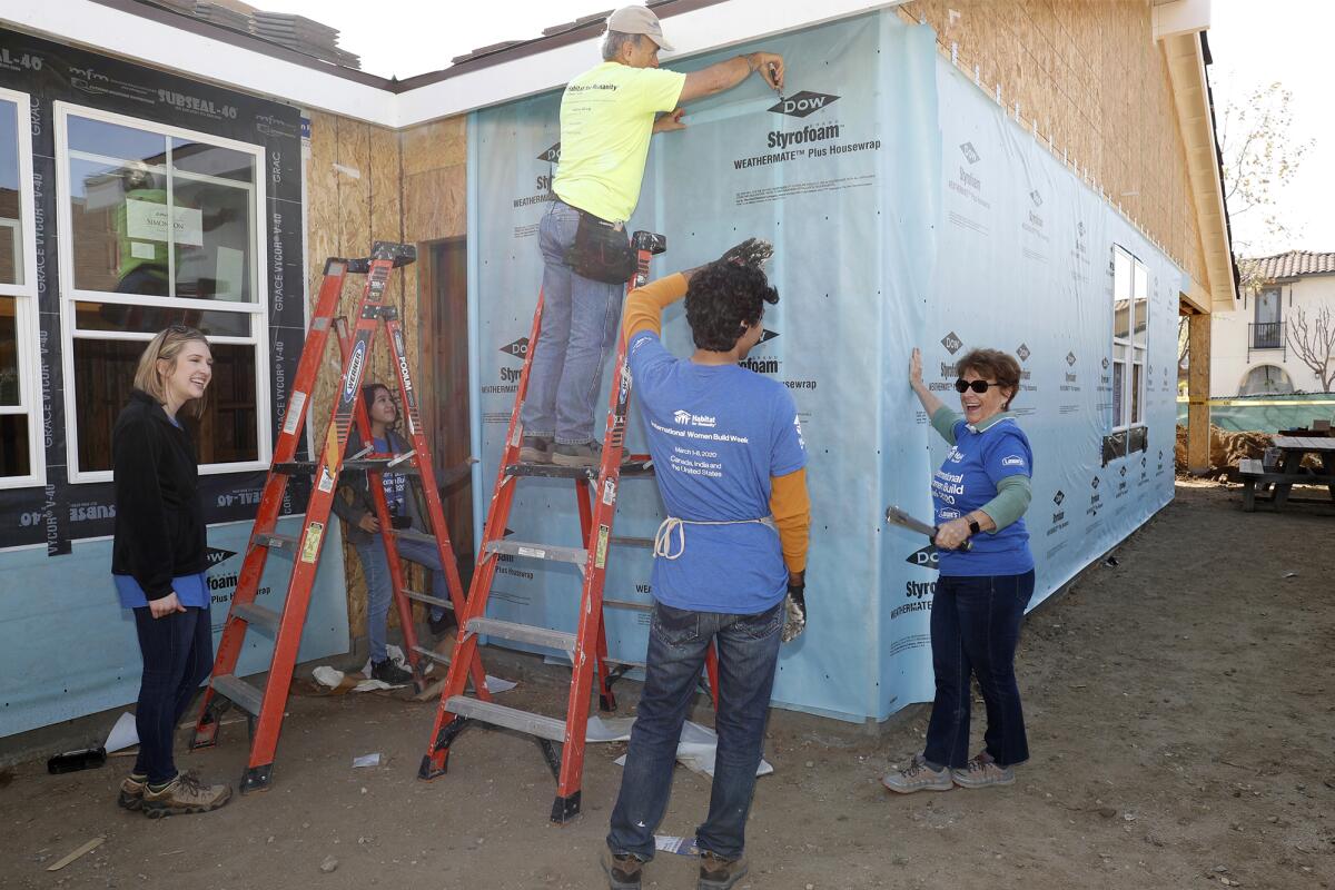 AmeriCorps volunteers join Habitat for Humanity of O.C.'s chief executive to build affordable housing in Fullerton.
