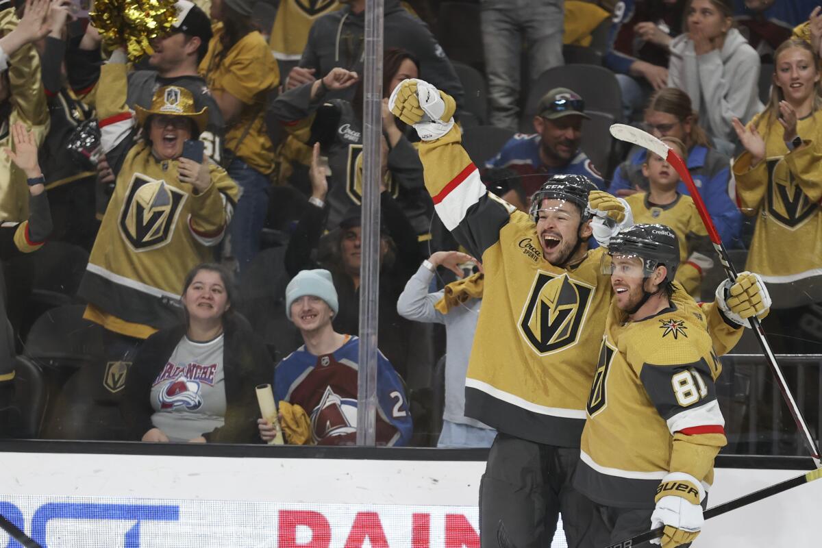 Vegas Golden Knights center Tomas Hertl (48) and Jonathan Marchessault (81) celebrate after Hertl's game-winning goal against the Colorado Avalanche during overtime of an NHL hockey game Sunday, April 14, 2024, in Las Vegas. (AP Photo/Ian Maule)
