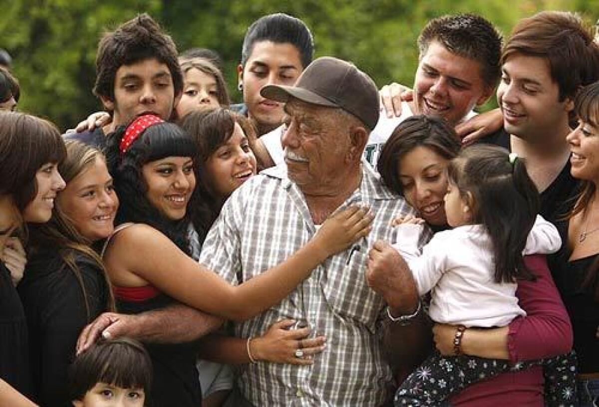 Ignacio Lujano, 84, is surrounded by some of his children, grandchildren and great-grandchildren at a family gathering at Swanner Ranch in San Juan Capistrano. Lujano has tended the orange groves for 38 years, but the city, which owns the property, is evicting him and his family so it can turn the ranch into a maintenance yard.