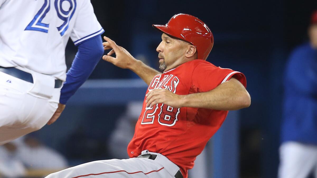 Angels designated hitter Raul Ibanez slides into home plate during Friday's win over the Toronto Blue Jays.