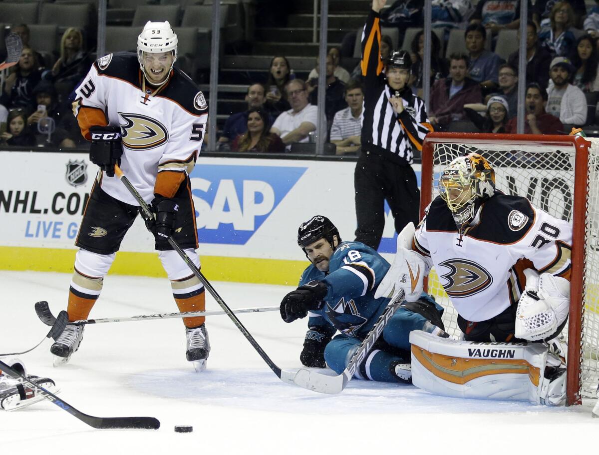 San Jose's Mike Brown collides with Ducks goalie Anton Khudobin on Saturday night.