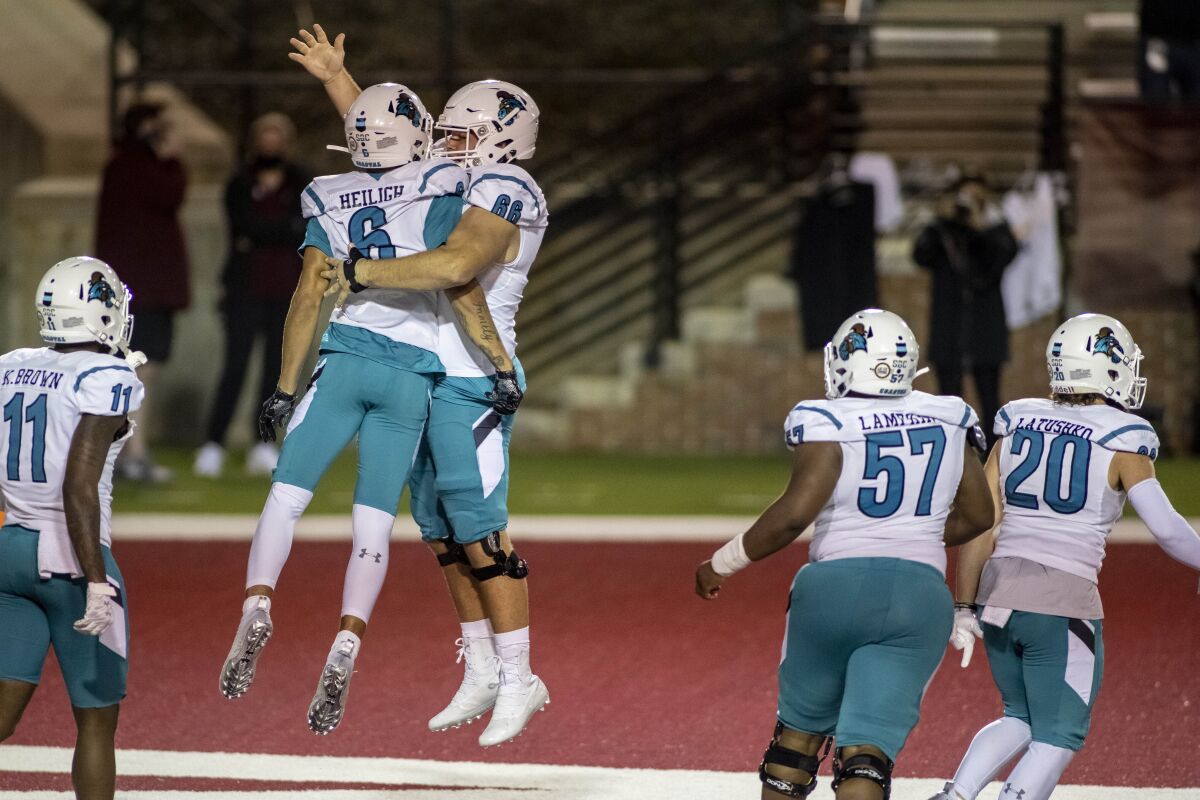 Coastal Carolina wide receiver Jaivon Heiligh (6) and teammate Will McDonald (66) celebrate Heiligh's touchdown against Troy during the second half of an NCAA college football game, Saturday, Dec. 12, 2020, in Troy, Ala. (AP Photo/Vasha Hunt)
