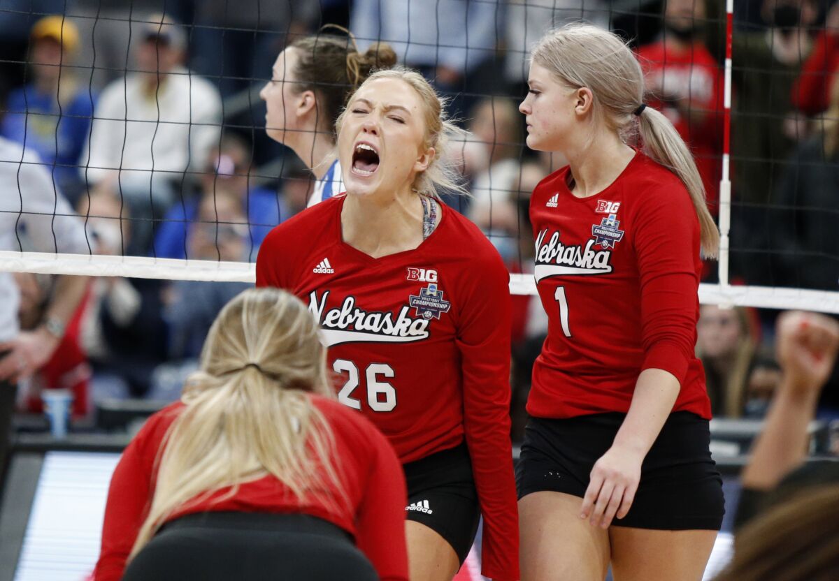 Nebraska's Lauren Stivrins, center, celebrates with teammates Ally Batenhorst, left, and Nicklin Hames following victory in a semifinal of the NCAA women's college volleyball tournament over Pittsburgh Friday, Dec. 17, 2021, in Columbus, Ohio. (AP Photo/Paul Vernon)