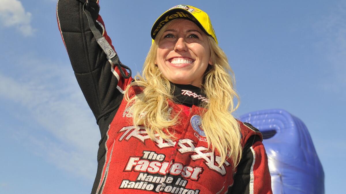 Courtney Force celebrates after her funny car win at the NHRA Midwest Nationals in St. Louis on Sunday.