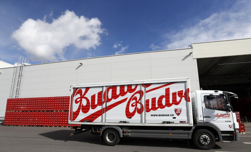 FILE - A truck drives past cases of beer at the Budejovicky Budvar brewery in Ceske Budejovice, Czech Republic, Monday, March 11, 2019. Budvar, the Czech brewer that has been in a long legal dispute with U.S. company Anheuser-Busch over use of the Budweiser brand, said Wednesday, June 29, 2022 its net profit reached 337 million Czech crowns in 2021 ($14.4 million), up by 10.5% from 305 million the previous year. (AP Photo/Petr David Josek, File)