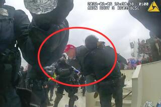 This image from police body-worn camera video, and contained and annotated in the Justice Department's sentencing memorandum, shows Kenneth Bonawitz colliding with two officer at the U.S. Capitol on Jan. 6, 2021, in Washington. Bonawitz, who assaulted at least six police officers during a mob's attack on the U.S. Capitol, has been sentenced to five years in prison. (Department of Justice via AP)