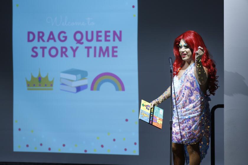 Raquelita, a drag queen, gets ready to read the book It's Okay To Be Different during Drag Queen Story Time at the Chula Vista Civic Center Library on Sept. 10, 2019.