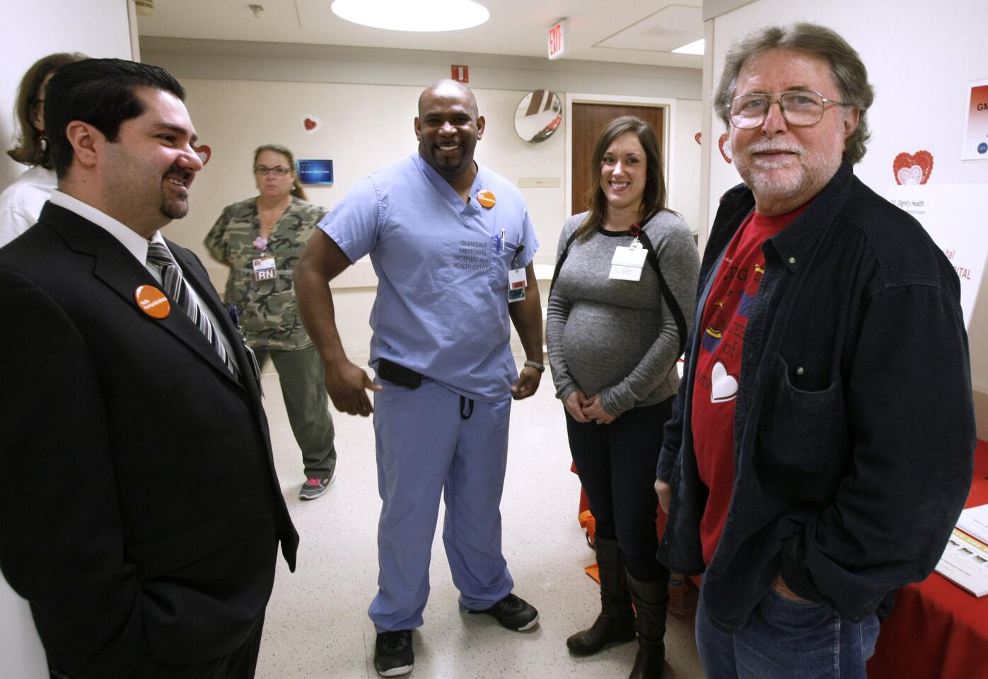 Rudy Donofrio, 66 of Glendale, right, got a chance to meet his life savers and hospital employees, left to right, Housni Hariri, Howard Ferguson and Michelle Carmichael, during the Kings and Queens of Heart celebration at Glendale Memorial Hospital in Glendale on Thursday, Feb. 20, 2014. Donofrio was having a heart attack in front of the hospital about 6 months ago when the aforementioned jumped into action and saved his life.