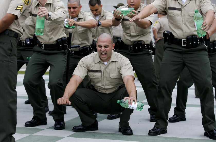 Los Angeles County Sheriff's Department recruits grimace in pain on the first day of training, known as "Black Monday."
