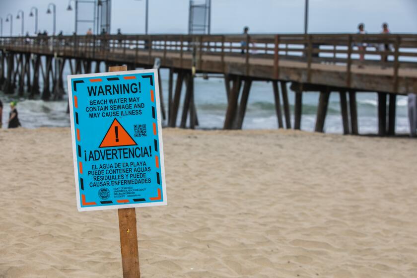 Imperial Beach Pier, CA - July 29: A sign warning visitors of possible water contamination near the Imperial Beach in Imperial Beach Pier, CA on Friday, July 29, 2022. (Adriana Heldiz / The San Diego Union-Tribune)