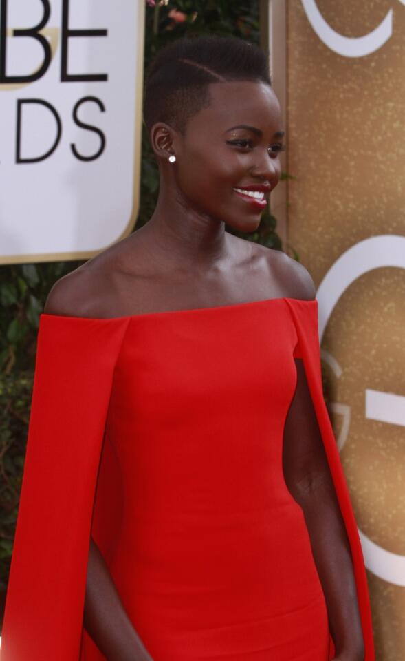 Actress Lupita Nyong'o wears a red Ralph Lauren gown to the Golden Globe Awards.