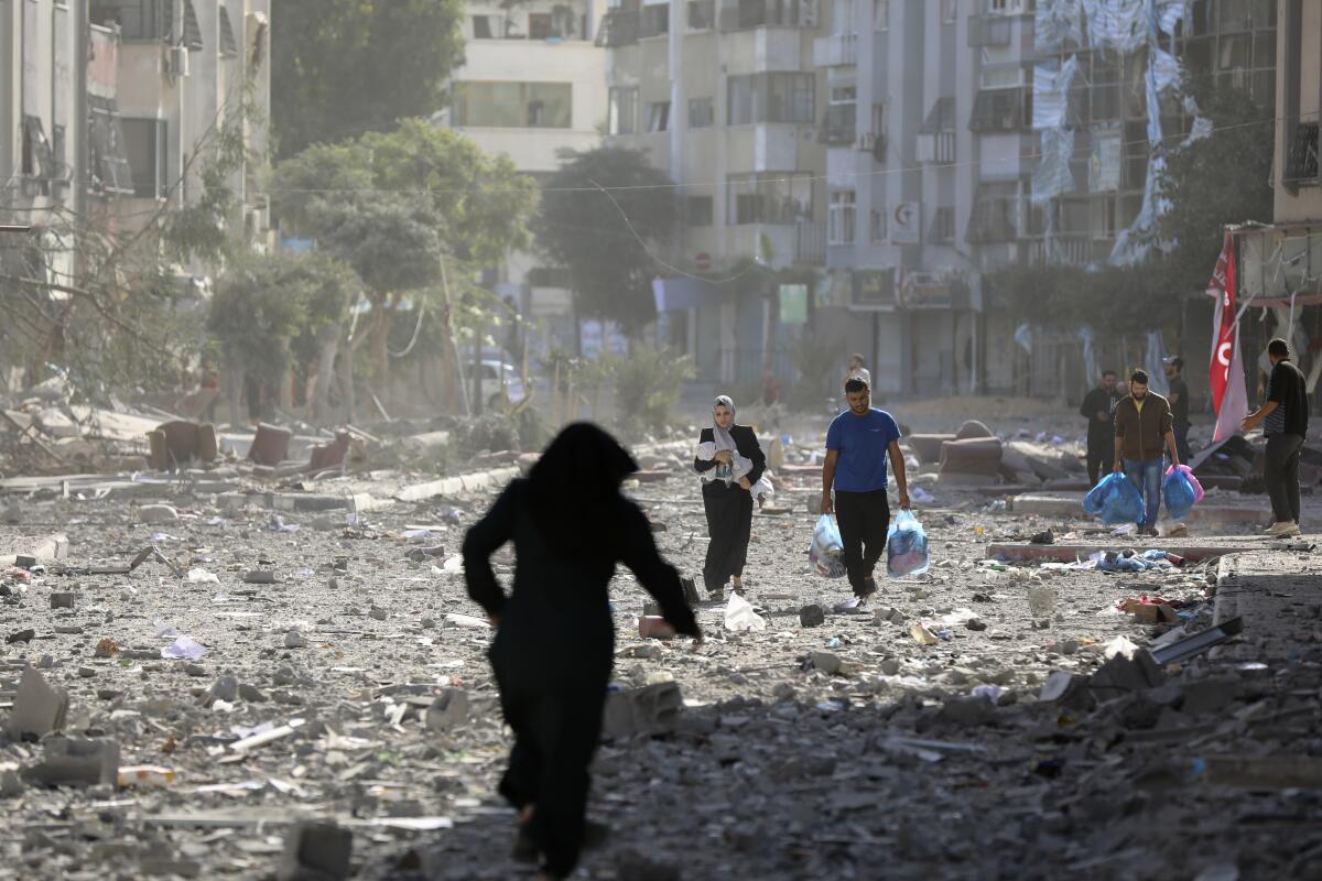 Palestinians leave their homes following Israeli bombardment on Gaza City.