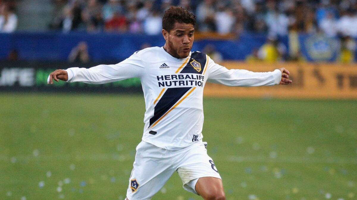 Jonathan dos Santos tries to control the ball during a match between the Galaxy and Sporting Kansas City last year.