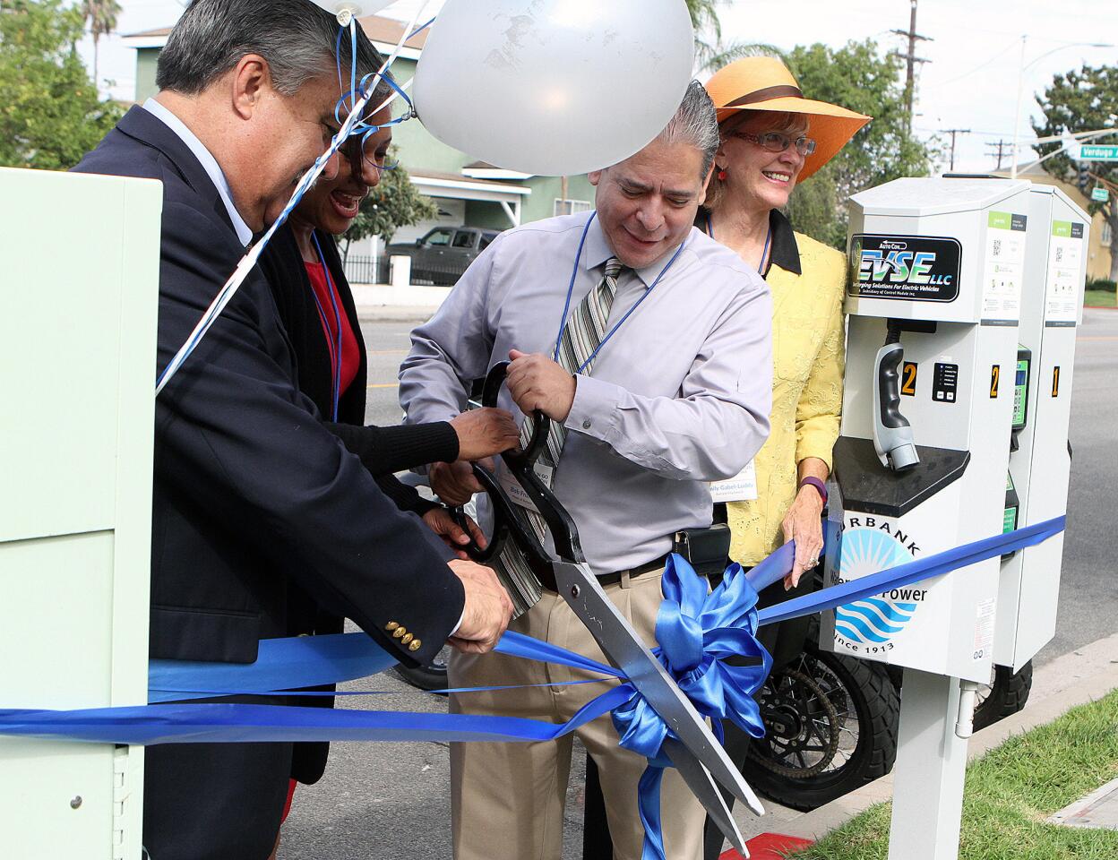 Burbank Mayor Bob Frutos, with Councilman Jess Talamantes, Burbank Water and Power's Janae Scott, and Councilwoman Emily Gabel-Luddy, cut the ribbon for one of the eight dual-charger, electric-vehicle charging stations in Burbank on Tuesday, Aug. 25, 2015.