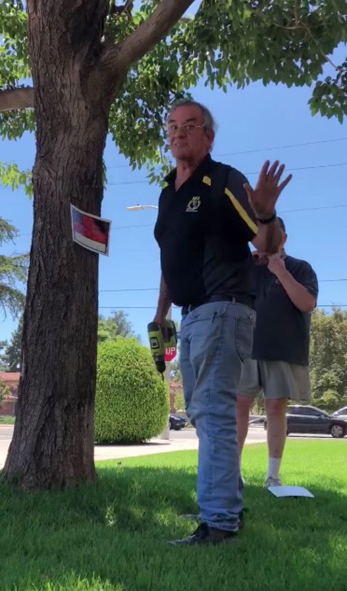 A screengrab from an iPhone video shows a man telling Marshall-Brown to leave after posting a "No Trespassing" sign.