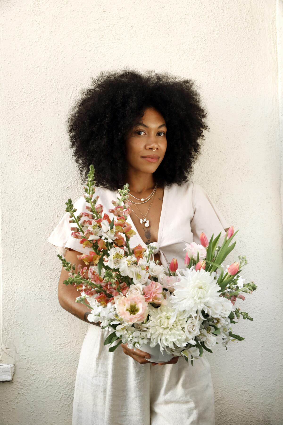 Schentell Nunn in her West Adams home with the arrangement she created with $40 worth of flowers from Trader Joe's.