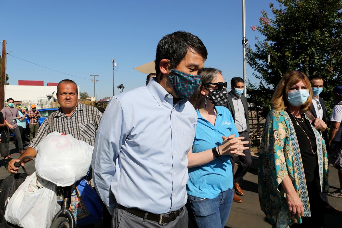 California Sen. Dave Min, front left, takes a tour of Mary's Kitchen in 2021.