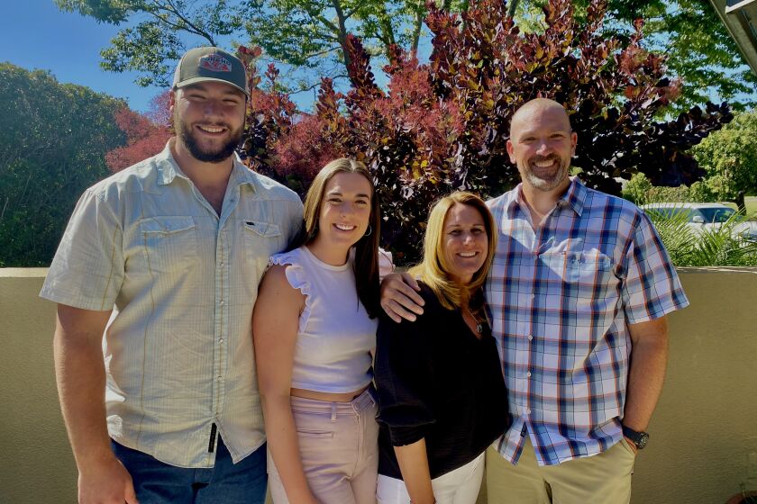Former UCLA football player Thomas Cole, left, is joined by his sister, Katie; his mother, Kelli; and father David.