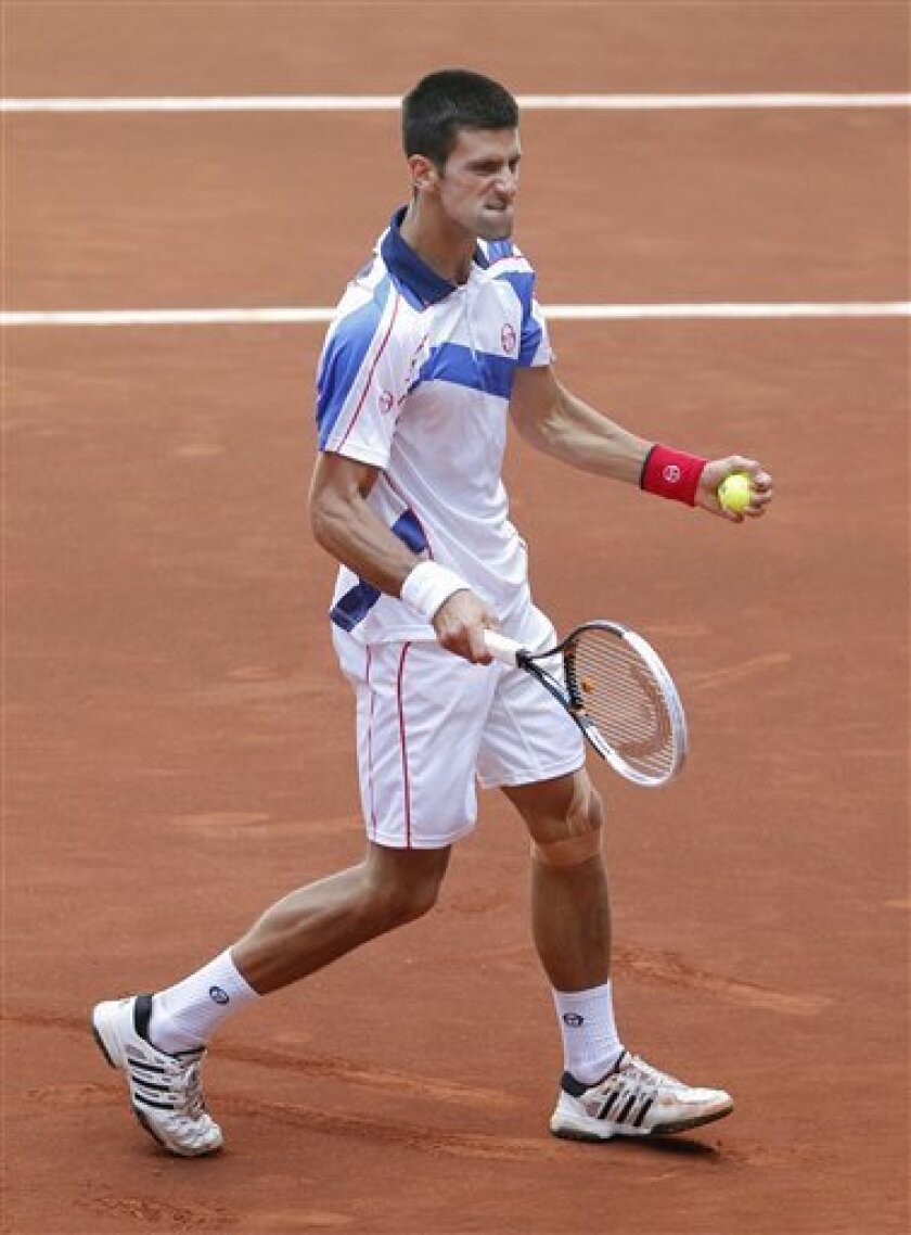 Serbia's Novak Djokovic celebrates during the match against Spain's Guillermo Garcia-Lopez in the Madrid Open tennis tournament in Madrid, Thursday, May 5, 2011.(AP Photo/Andres Kudacki)