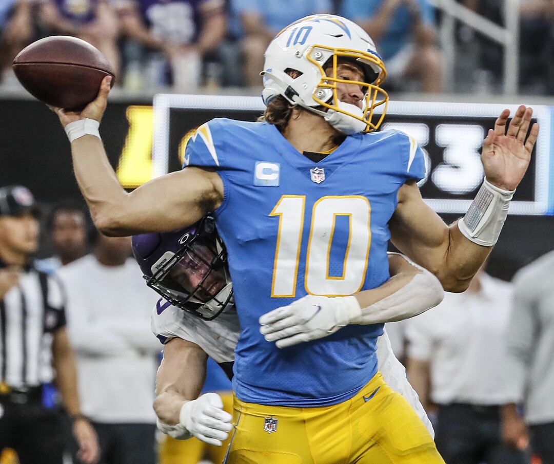Minnesota Vikings outside linebacker Nick Vigil hits Chargers quarterback Justin Herbert.
